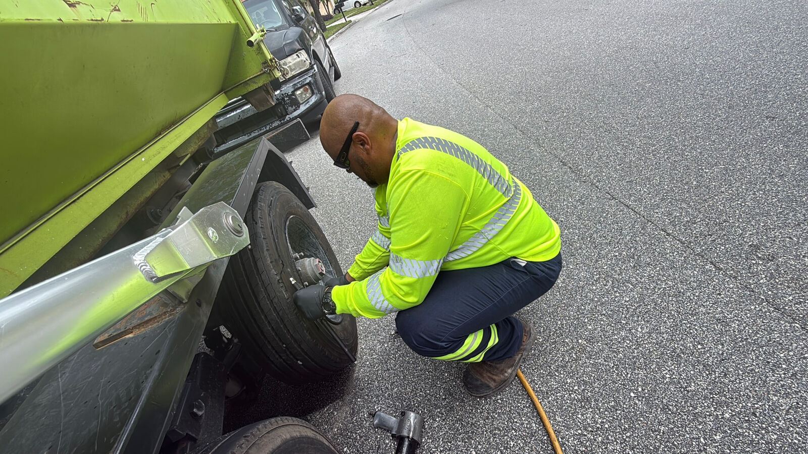 MTS technician changing a truck tire on the street